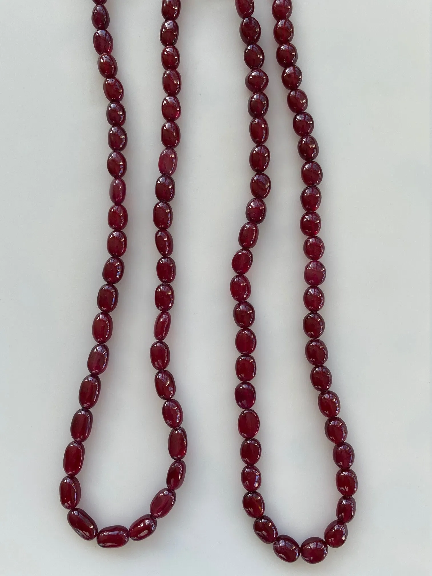 Ruby, Dark Red Color with great transparency, Oval Shape, Plain, Earth Mined, Glass Filled, Oval/Tumble Shaped Plain ruby, 16 inches Strand.